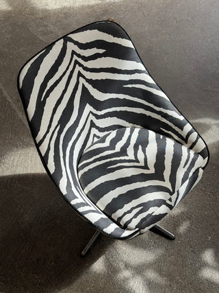 Vintage swivel armchair upholstered in black zebra